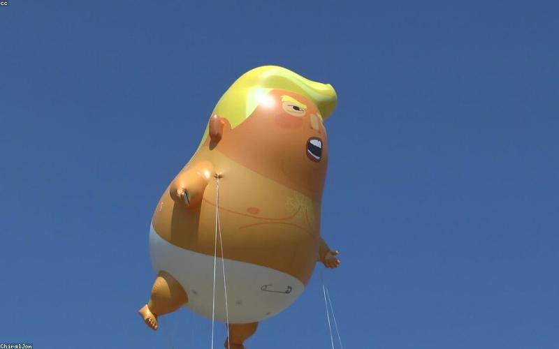 News anchors reporting on a TV screen with graphs and political headlines