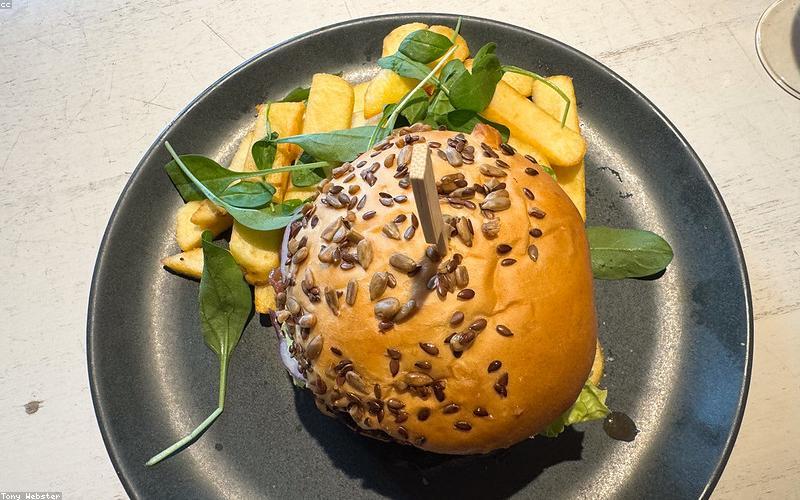 Vibrant street food stall with fusion Pakistani dishes like gourmet chaat bowls and loaded fries