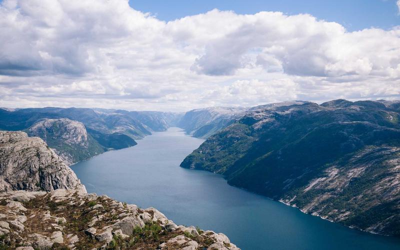 A vibrant fruit chaat bowl with dates and a glass of Rooh Afza/lemonade