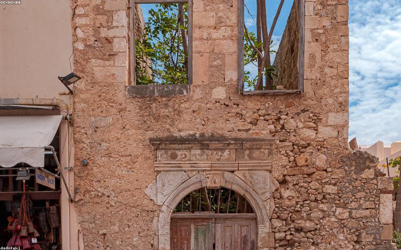A person relaxing on a sofa with a book, with light coming through the window