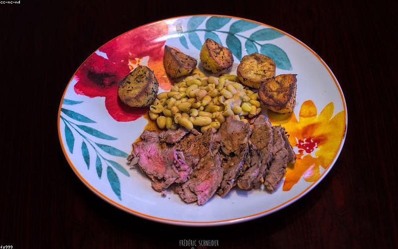 Vibrant close-up of fresh chicken pieces, chopped tomatoes, green chilies, and a bowl of ginger-garlic paste, ready for cooking.