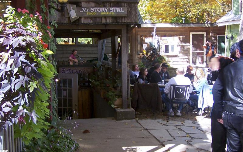 A dynamic TV news studio with a Pakistani news anchor passionately reporting a breaking story