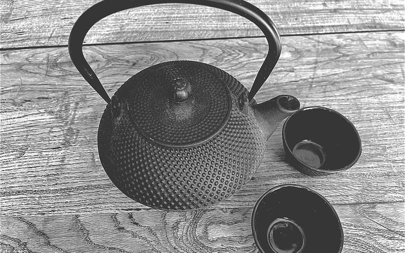 A beautifully presented deconstructed chai set with separate small glass bowls for milk, tea concentrate, and spices, alongside delicate cups.