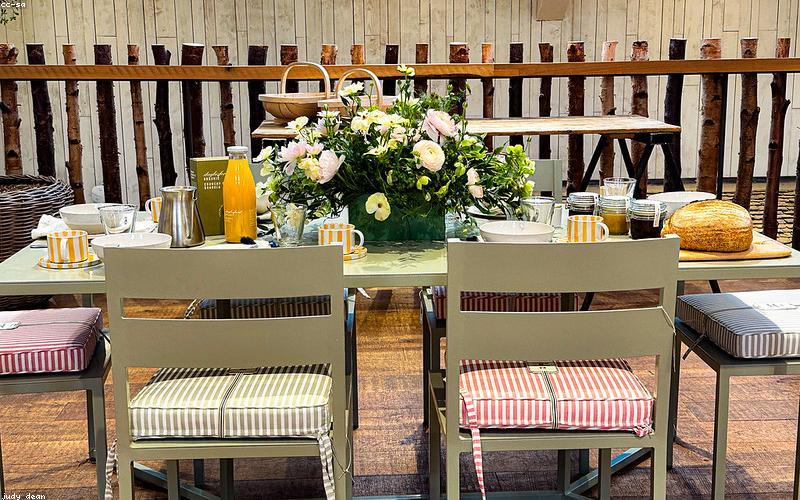 An aesthetic close-up of a unique flavored chai (e.g., hazelnut or saffron chai) in a stylish ceramic mug on a wooden table.