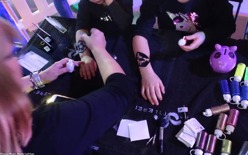 People excitedly watching a news broadcast on a big screen with headline about 