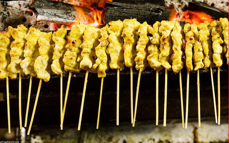 A colourful and healthy Iftar spread with fruits, dates, salad, and grilled chicken skewers