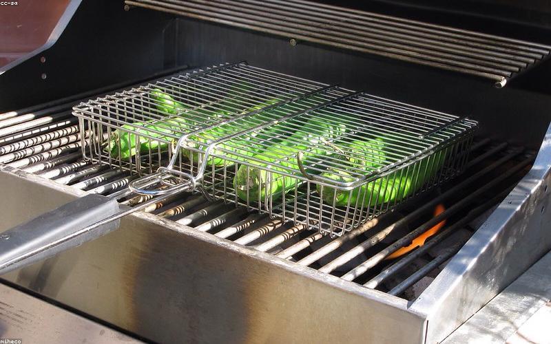 Chicken Karahi sizzling in a black karahi pot, garnished with ginger and green chilies