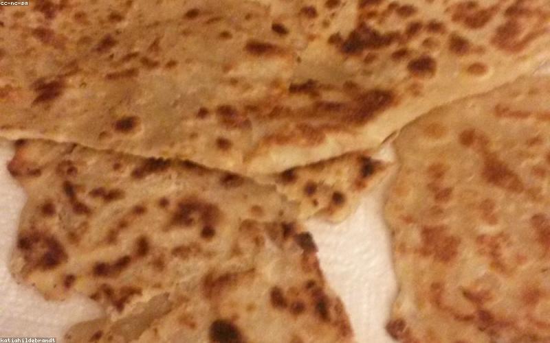 A vibrant spread of healthy Sehri items like yogurt, dates, fruit, and whole-wheat paratha.