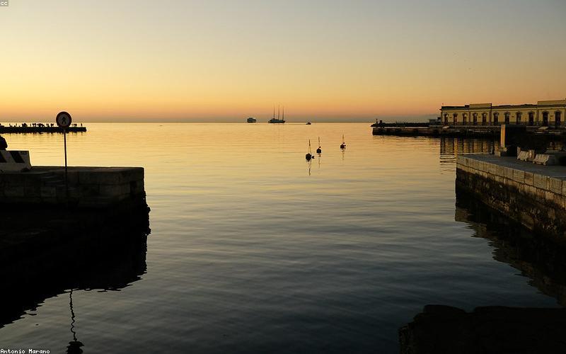 A lively, aesthetically pleasing outdoor seating area of a desi brunch cafe, full of young people laughing and enjoying food.