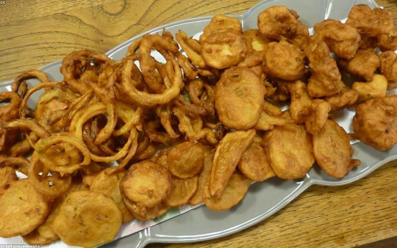 Collage of various fancy street food items like deconstructed chaat, specialized bun kababs, and gourmet pakoras.