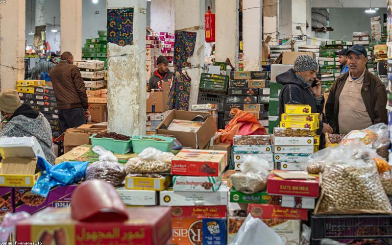 A vibrant spread of healthy iftar items like fruit chaat, chana chaat, water, and dates.