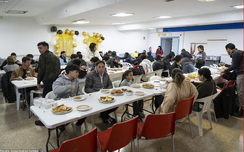 A family taking a light walk in an evening park after iftar.