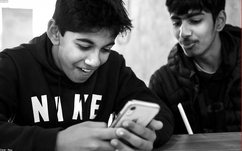 A bustling, well-lit cafe in Lahore with people chatting and laughing