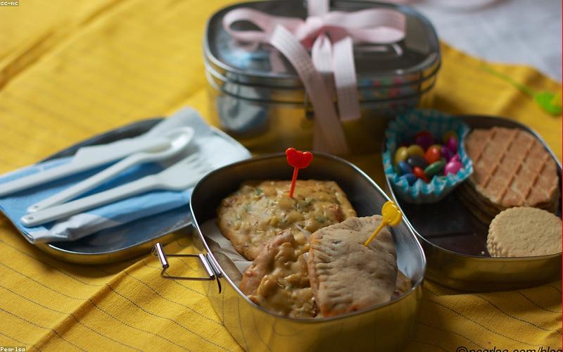 A close-up shot of a steaming cup of doodh patti chai with some local snacks like samosas or pakoras