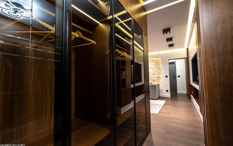 A refreshing glass of infused water with lemon, mint, and cucumber slices, looking cool and inviting.