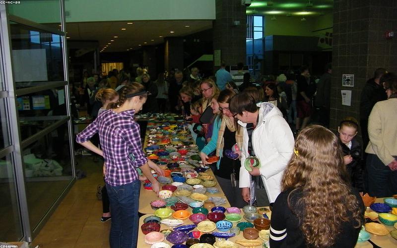 A colourful table spread with healthy iftar options like fruit salad, dates, yogurt, grilled chicken skewers, and a light lentil soup.