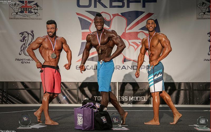 A vibrant image of a Pakistani street scene with people engaged with their smartphones, possibly a mix of old and new models.
