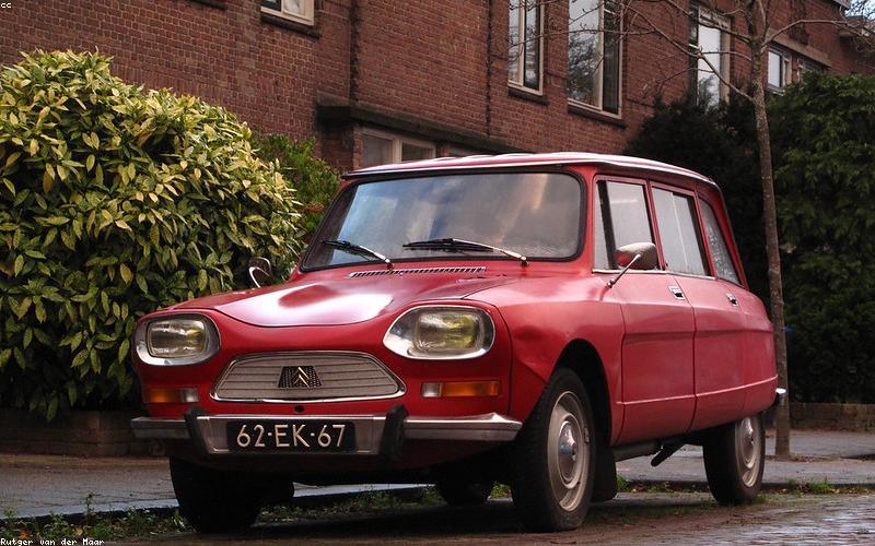 A Pakistani family smiling brightly in their living room, lit by solar power during a load shedding break