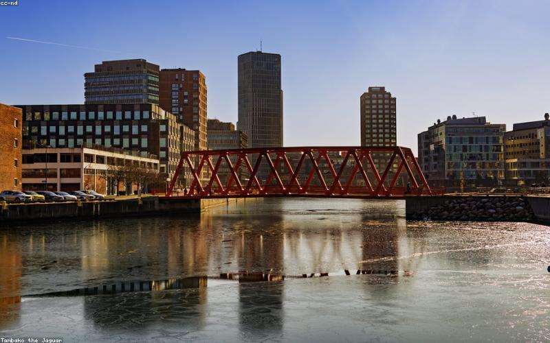 A modern, sleek flexible solar panel being rolled out on an uneven surface