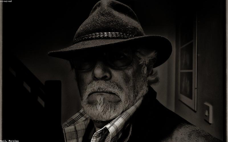 A cozy, dimly lit bedroom with a soft blanket and a pillow, suggesting a peaceful environment for rest and sleep.