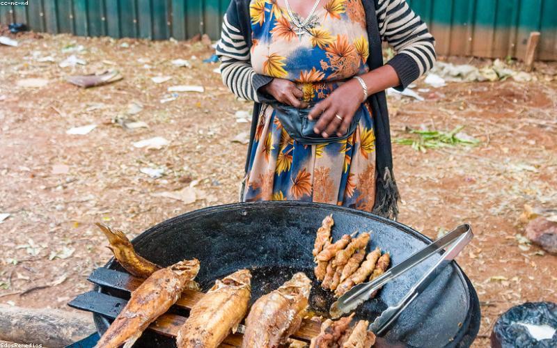Fresh Karahi ingredients laid out beautifully on a wooden board: chicken pieces, tomatoes, ginger, garlic, green chilies, coriander, spices