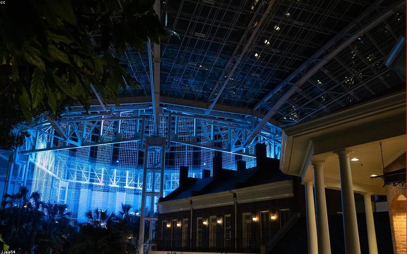 A Pakistani family happily enjoying electricity at home with solar panels visible on the roof.