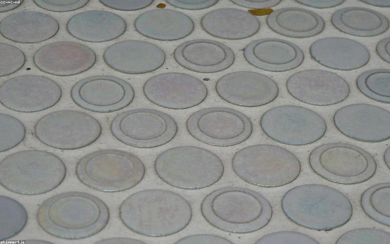 A futuristic skyscraper with integrated transparent solar panels on its windows, glowing subtly.