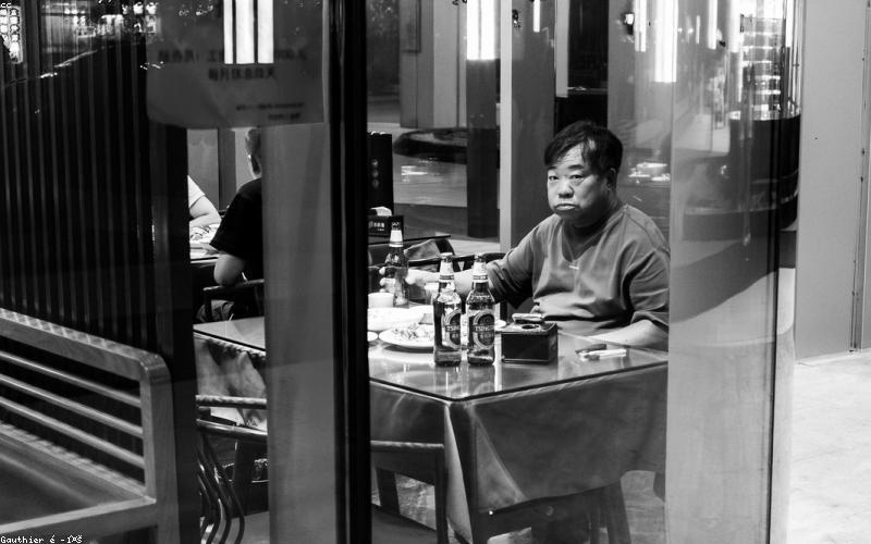 A collection of sleek, modern portable solar chargers, a solar-powered security camera, and a solar garden light displayed on a minimalist table.