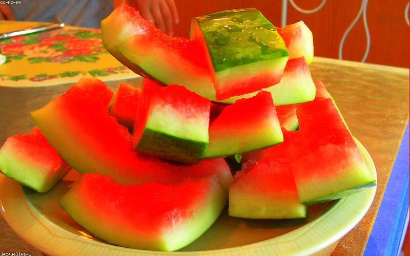 A vibrant, sizzling Chicken Karahi served in a traditional karahi pot, garnished with fresh ginger and green chilies, ready to be devoured.