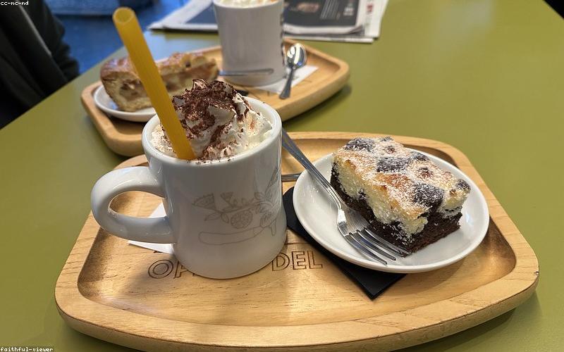 A vibrant, modern Pakistani cafe interior with people enjoying chai and snacks.