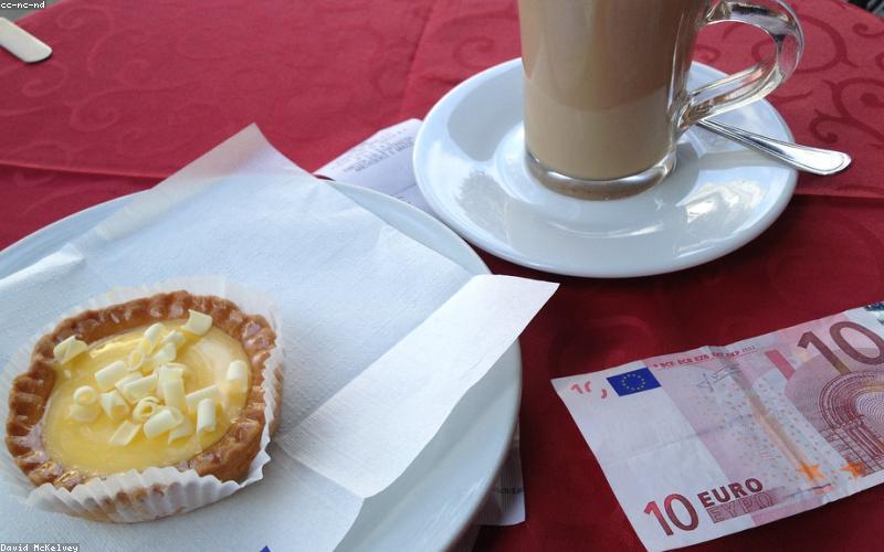 A group of friends laughing and taking selfies at a trendy cafe.