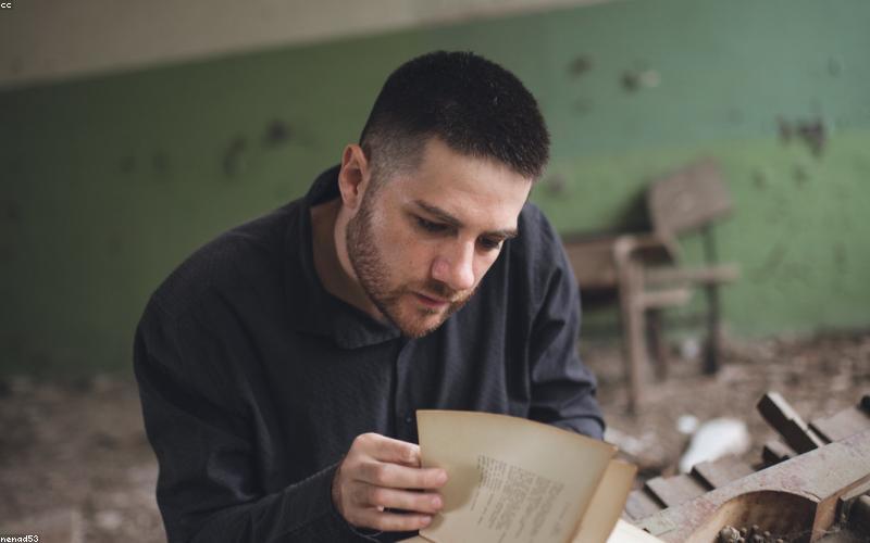 A scientist holding a transparent, flexible solar film in a high-tech lab setting