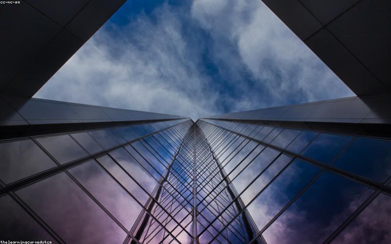 A person unfolding a foldable phone in a bustling Karachi street.