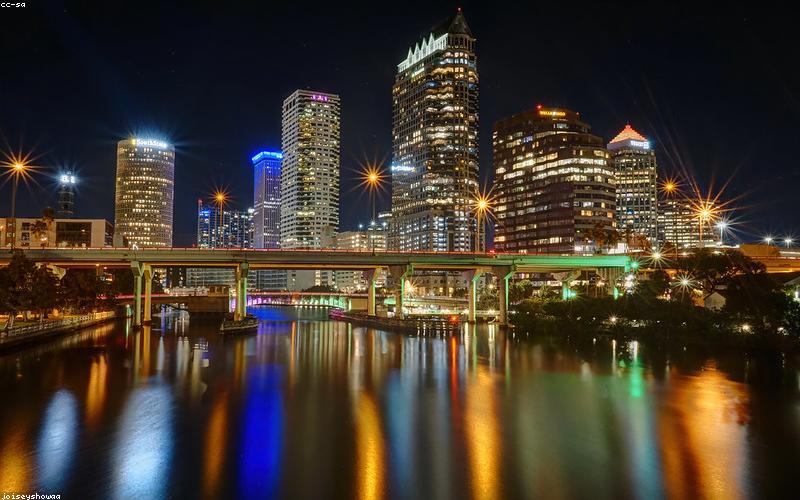 Finished Chicken Karahi in a serving bowl, garnished with coriander and green chilies, with naan on the side