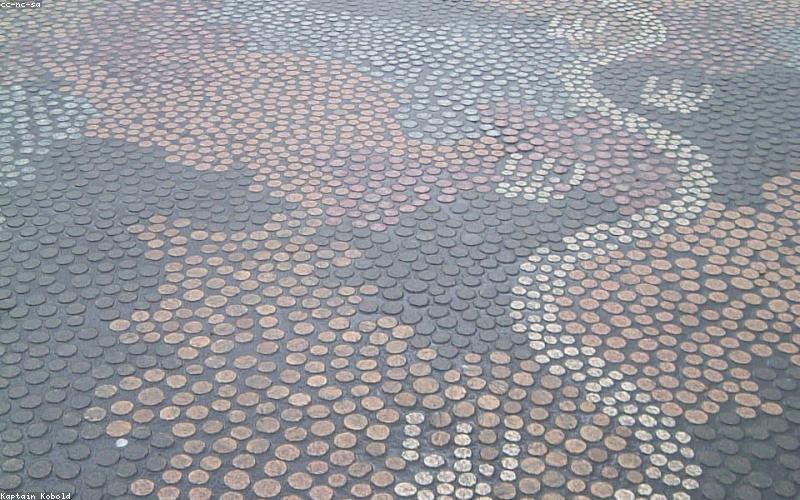 A confused looking Pakistani citizen scratching their head in front of parliament
