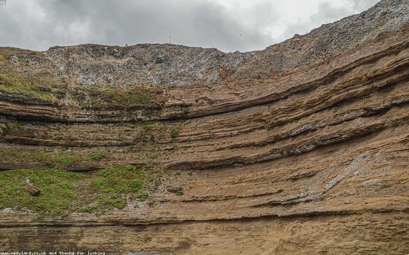 A person holding a Samsung Z Fold phone in a busy Pakistani street setting